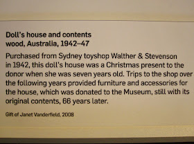 Museum sign for 'Doll's house and contents wood, 1942-47'