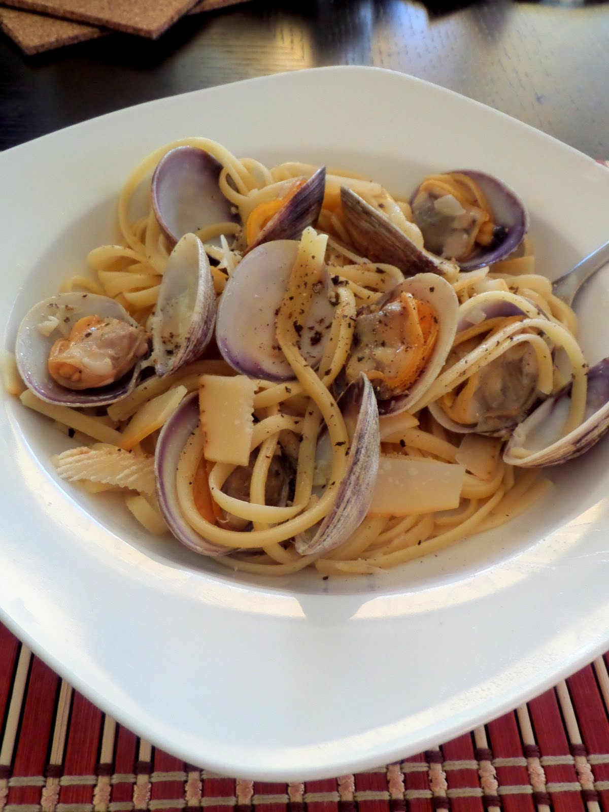 Clam Linguine:  Clams cooked in white wine sauce then tossed with linguine.  A delicious dinner that may look fancy but is really quite simple.