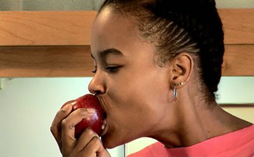 Black woman eating apple