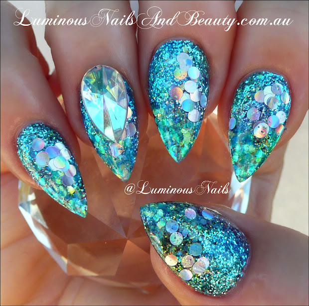 luminous nails glittery blue acrylic
