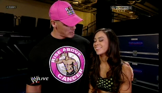John Cena tells AJ he is happy she is competing again and hugs her
