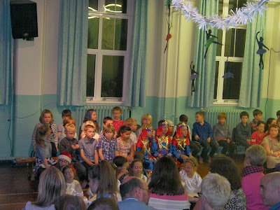kids in school play wise men shepherds angels nativity in front of parents