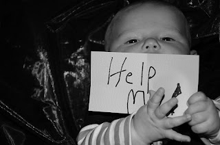 Baby with a Help Me sign