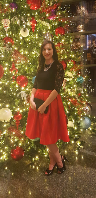 Christmas Outfit Idea: Red pleated Skirt and black lace top with statement necklace