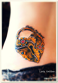 a lock tattoo on the hip with Egyptian style of decoration