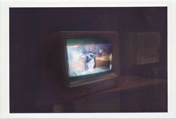 dirty photos - a - dark photo of girl on videocamera shop window