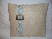 beige pillow with vintage buckle