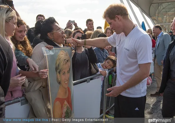 Prince Harry looks at a photo of his mother, Princess Diana shown by Faasiu Gaee from Samoa as he meets members of the public at an event to promote the 2015 FIFA U-20 World Cup which will be hosted by New Zealand, at The Cloud on Auckland's waterfront on May 16, 2015 in Auckland, New Zealand