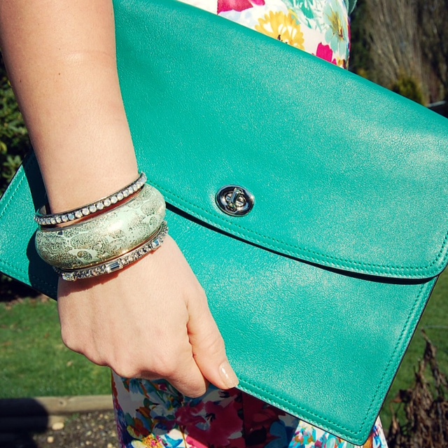 Floral scuba skirt, mint Forever 21 sweater and a green Coach Legacy iPad clutch.