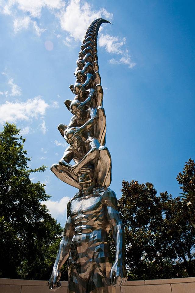 Karma is an intriguing sculptural installation by Korean artist Do Ho Suh that presents countless men sitting atop one another while shielding each other's eyes. Like his Cause & Effect piece, which features a spectacular tornado of figurines, Karma presents figurative sculptures ascending into the sky like a human ladder. 