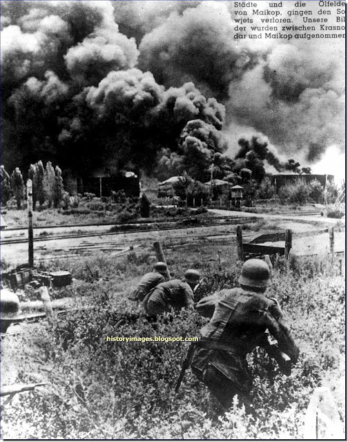German soldiers approaching burning oil storage tanks ​​Maikop  Krasnodar. October 1942