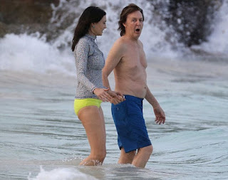 Nancy Shevell, 56, developing her natural charm in a gray top and yellow bikini and the Beatles musician, Sir Paul McCartney, 73, covered his muscle in a blue trunks as they wandered around the sea of Saint-Barthélemy on Monday, December 28, 2015.
