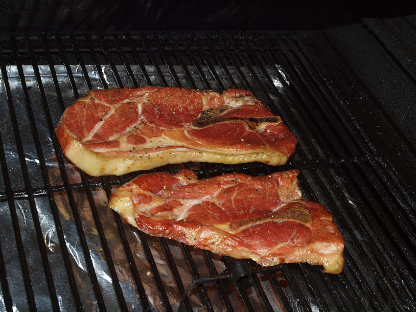 Pellet Smoker Cooking Pork Steaks and Fried Potatoes
