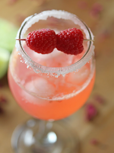 Close up view of Gin Rickey in a serving glass with raspberry garnish