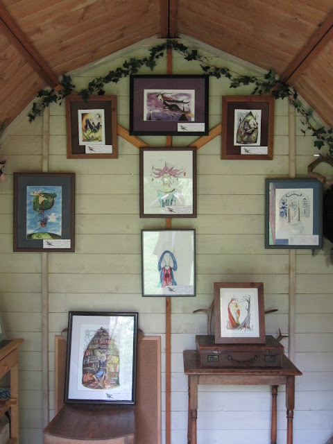 Painted back wall hung with pictures - Sarah Turpin