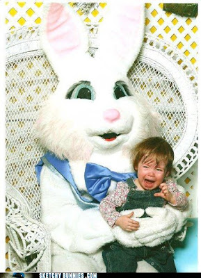 A crying child sits with a bunny-costumed adult