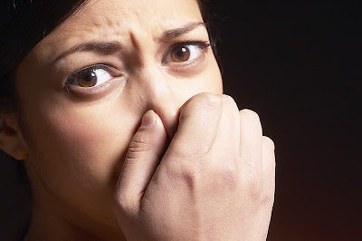 Woman-holding-nose.jpg