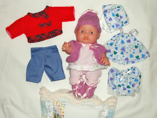 Baby doll and all her handmade clothes