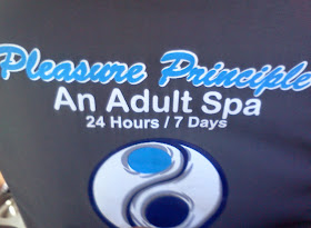 Pleasure Principle Adult Spa Ad in back of taxi