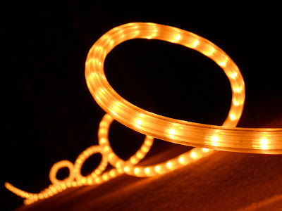 coiled string of white rope lights at night
