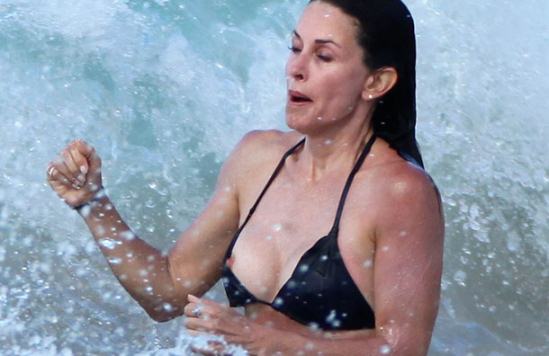 Courteney Cox popped out of her bikini while swimming in the Caribbean surf