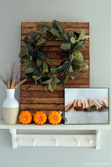 A kitchen beautifully decorated for Fall with sheet music garlands, mini pallet art, and more!