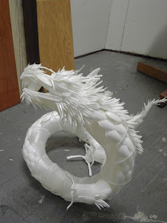 Plastic Dragon made out of plastic kitchen utensils
