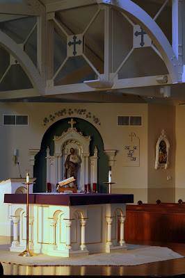 High Alter with Liturgy book and St. Joseph Altar in Background