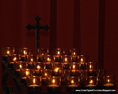 Grouping of tea lights and cross.