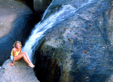 Girl next to waterfall