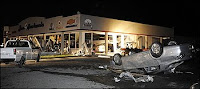 An overturned car sits in the lot of Jim Robertson car dealership after it was hit by a tornado Wednesday, May 13, 2009, in Kirksville, Mo. Multiple tornados hit the area as severe storms tore through the state. (AP Photo/L.G. Patterson)