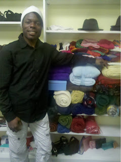 Xzavier poses with blankets in the Montrose Grace Place clothes closet