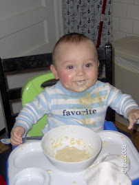Repugnant baby trying to feed himself (unsuccessfully)