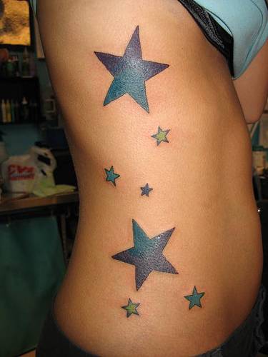 Star tattoo between thumb and index finger on her right hand