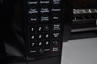 Sticky popped out buttons stuck onto the microwave on the 3, 0 and start buttons