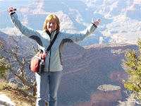 woman stands at the edge of the Grand Canyon
