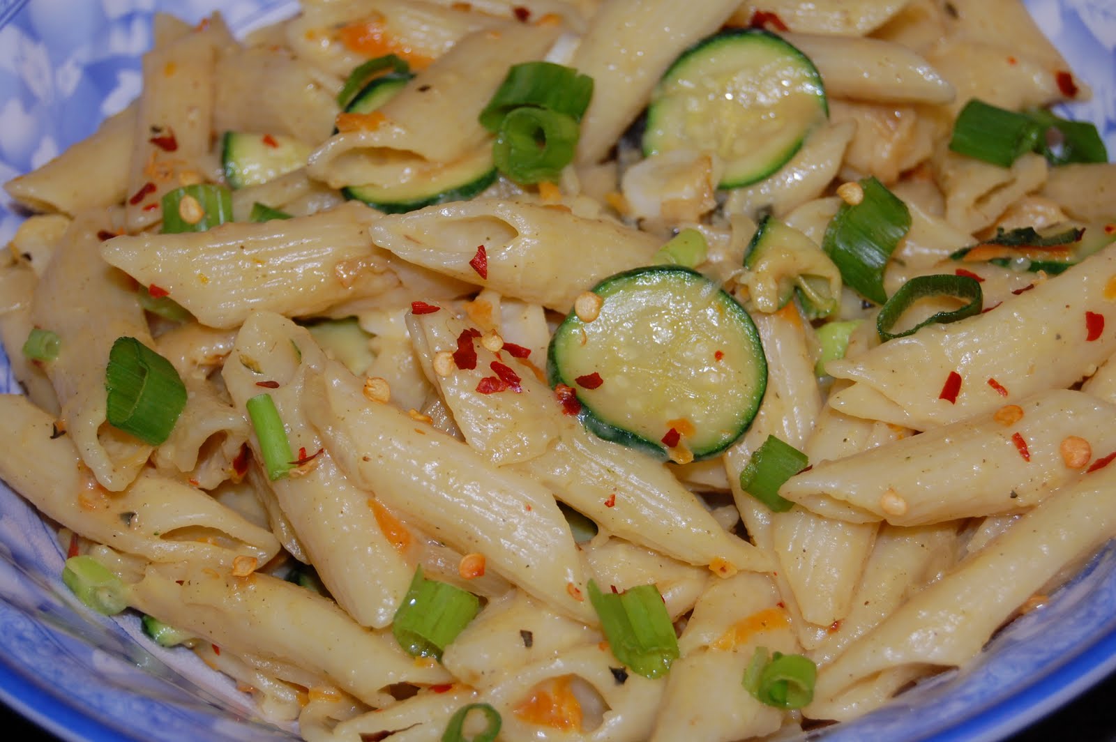 Penne pasta with veggies in cheesy garlic sauce