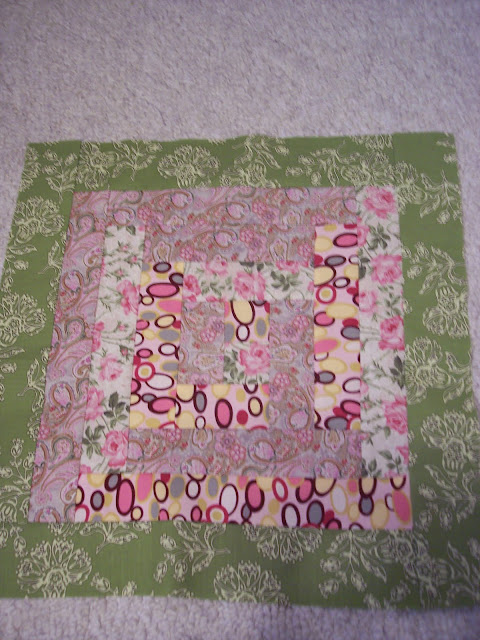 Pink quilt fabric made into pillows using log cabin quilt pattern