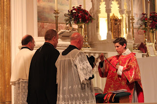 Deacon censing the priests sitting 'in choro'.