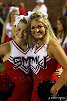 Blond SMU cheerleaders smile.