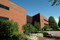 Two story brick building with lettering labeling the structure as the UAB School of Engineering.