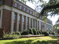 Sunlit side view of brick building on college campus setting.