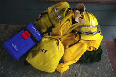 hard hat, protective clothing, and fire pack. photo by Chas S. Clifton