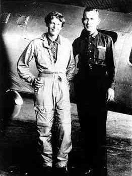 Aviatrix Amelia Earhart and her navigator, Fred Noonan, pose in front of their twin-engine Lockheed Electra in Los Angeles in May 1937. (AP Photo)