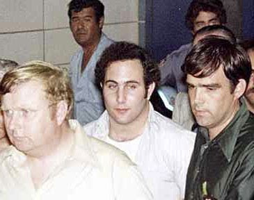 Police officials surround 'Son of Sam' killer David Berkowitz outside Brooklyn's 84th precinct on Aug. 11, 1977, the day after his arrest. (AP Photo)
