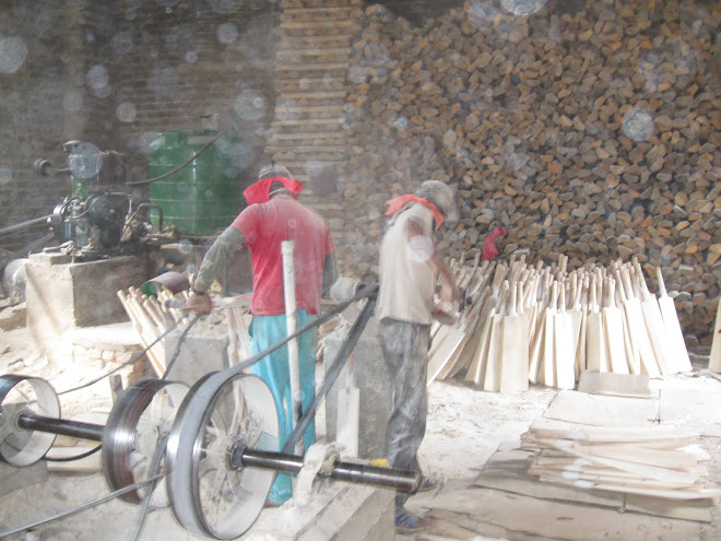 Shaping the cricket bats.