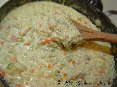 Creamy Alfredo sauce with chicken, onions, garlic, celery, and carrots ready to layer with the fusilli for the timbale