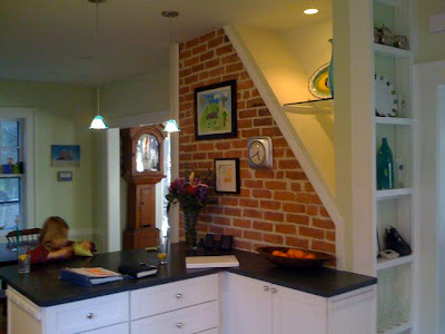 Kitchen after remodeling with exposed brick accent wall