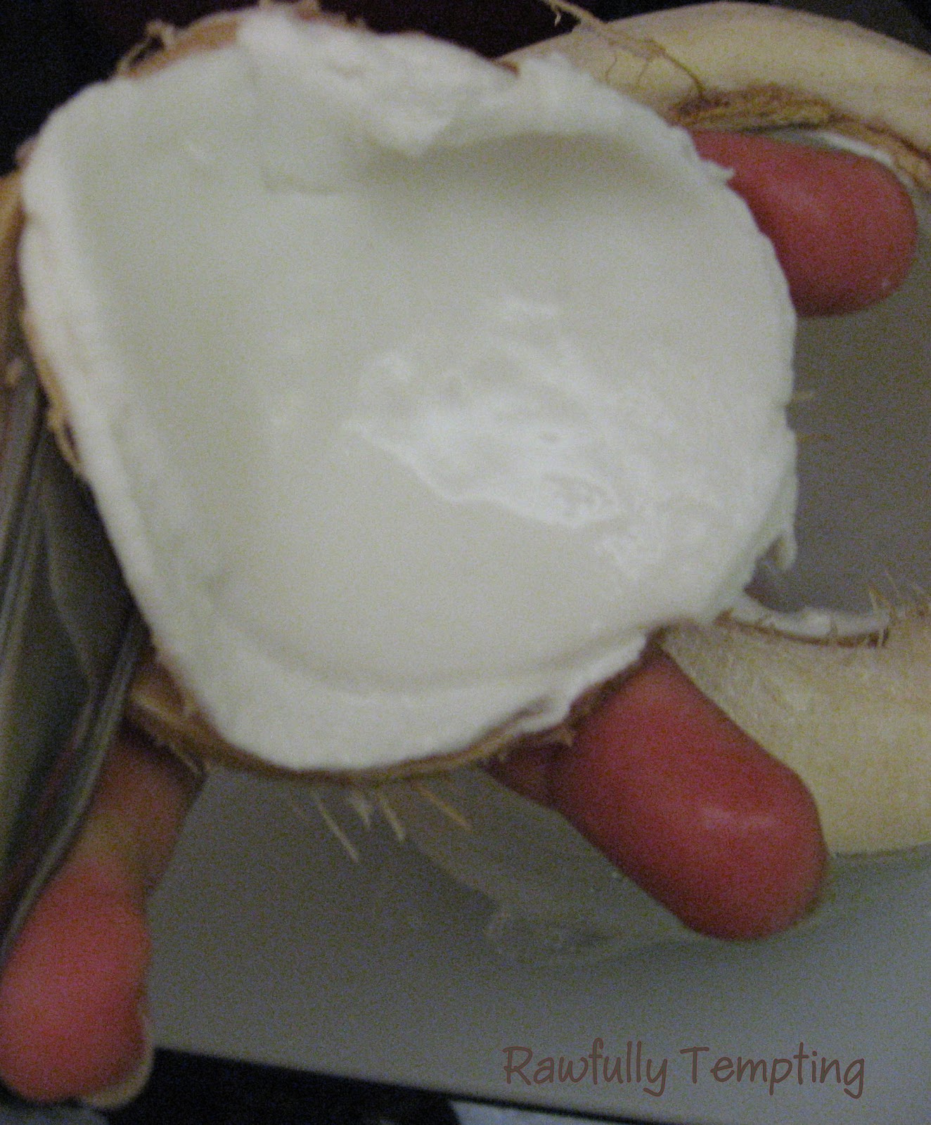 Using handle edge of spoon, wedge it between the shell and the meat and