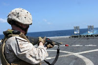 Marine Cpl. Cole Daniels trains with a shotgun aboard the amphibious transport dock ship USS San Antonio. San Antonio is the command ship for Combined Task Force 151. The task force conducts counter-piracy operations in and around the Gulf of Aden, Persian Sea, Indian Ocean and the Red Sea and was established to create a lawful maritime order and develop security in the maritime environment.